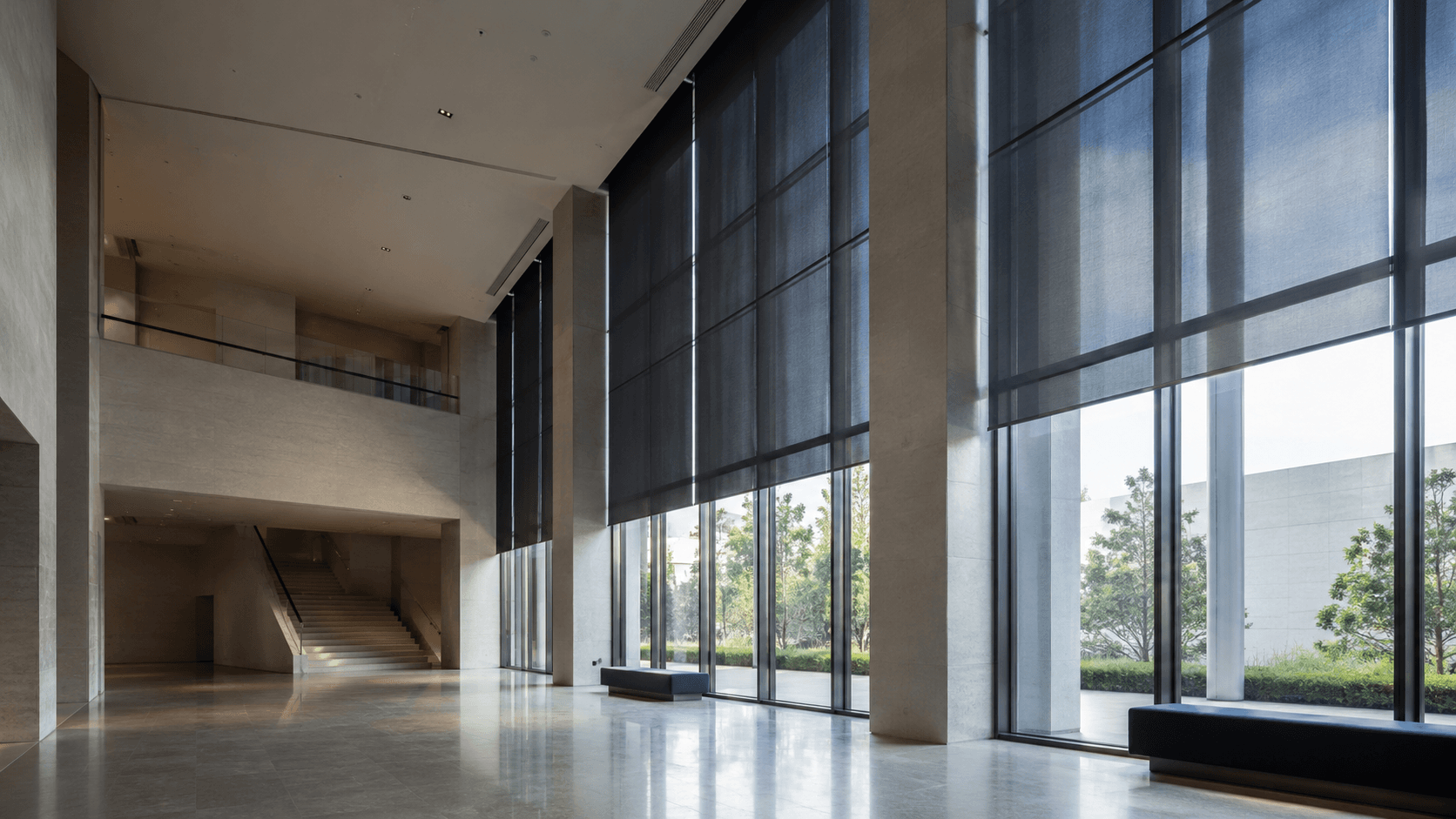 Cultural gallery with controlled daylight through solar screens on the facade