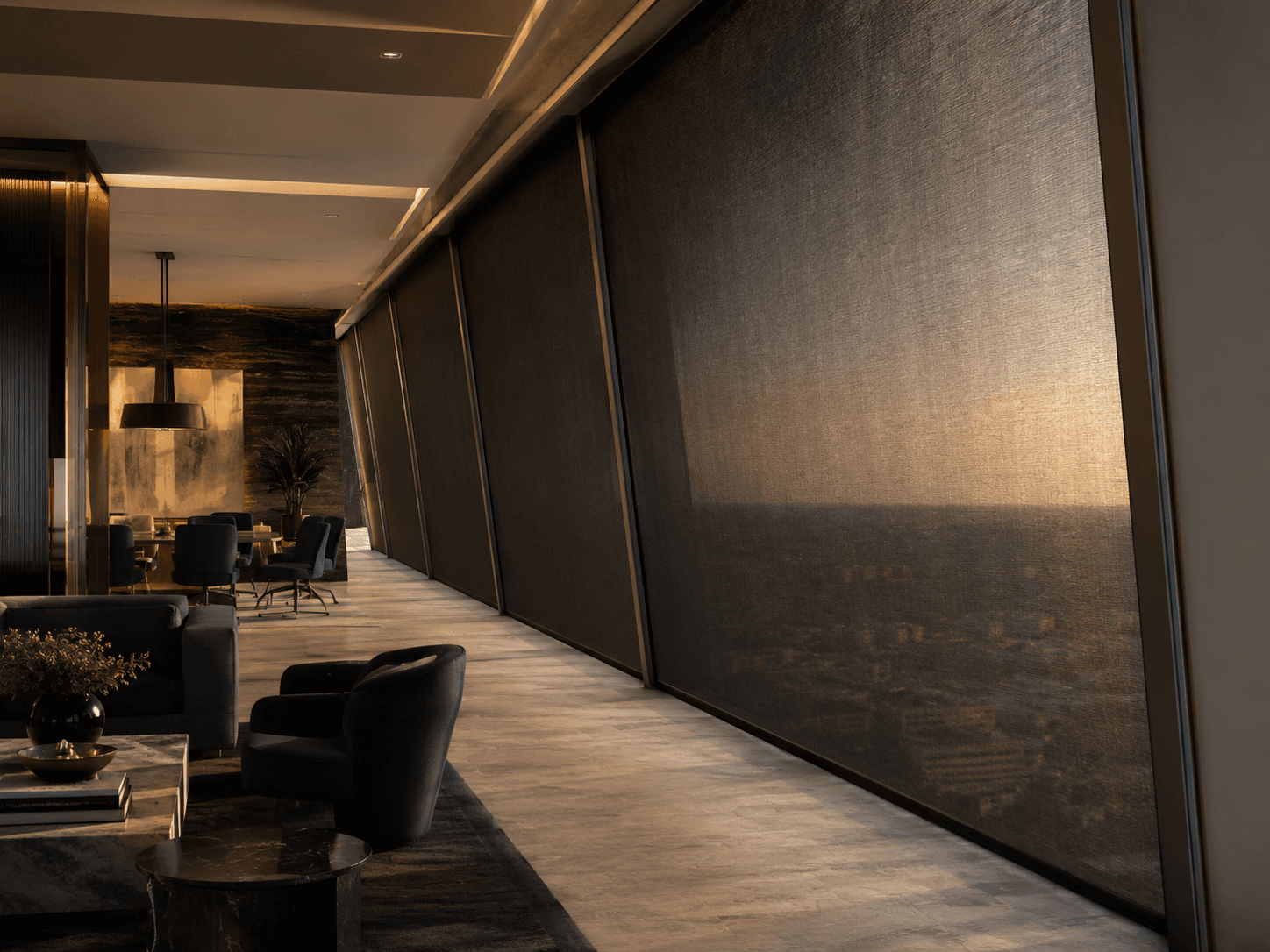 SUNZIP zip-guided screen held flat to a curtain-wall glazing line by lateral channels